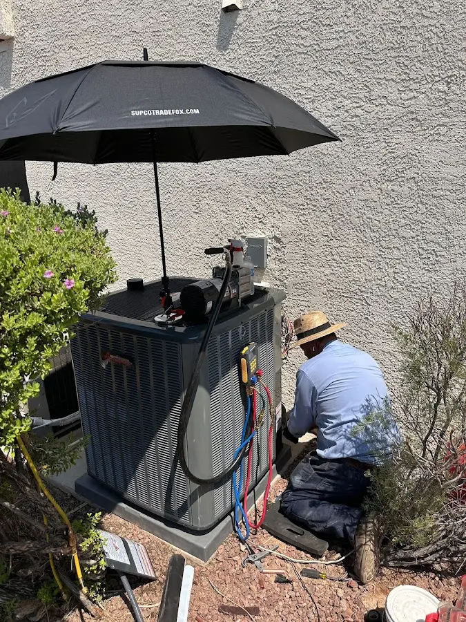 HVAC technician performing outdoor AC maintenance in Highland
